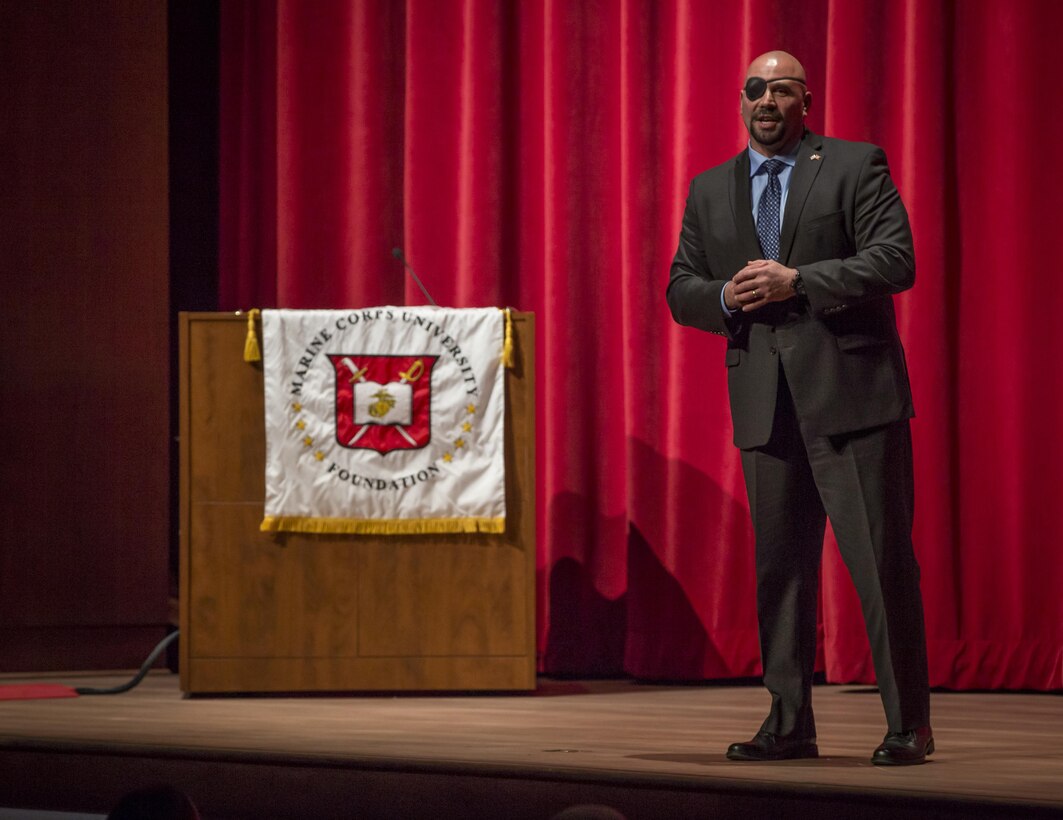 Retired U.S. Marine Corps Gunnery Sgt. Nick A. Popaditch, supervisor at Tesla Motors, speaks about the actions of Sgt. Walter K. Singleton during the 17th Annual Sgt. Walter K. Singleton Distinguished Lecture Series held at Warner Hall, Marine Corps Base Quantico May 8.  Singleton was killed in action in Vietnam and was posthumously awarded the Medal of Honor in 1968. The lecture series is held to broaden the leadership perspective of the Corps' future leaders attending the Staff Noncommissioned Officer Academy.