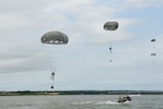 Members of the 181st Weather Flight parachute into Lake Worth after jumping out of a C-130 Hercules during a deliberate water drop in Forth Worth, Texas, May 20, 2017. The training mission was scheduled for members to practice airborne covert water parachute infiltration and included a joint effort between the Texas Air National Guard, Army, Coast Guard Auxiliary and local fire department.
