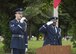 Senior Airman Josh Dinan, Dover Air Force Base Honor Guard member, sings the national anthem as Tech. Sgt. Isaiah Martin, Dover AFB Honor Guard NCO in charge, salutes during a Memorial Day commemoration May 29, 2017, at Sharon Hills Memorial Park in Dover, Del. The Honor Guard provided a ten-man team to perform ceremonial duties. (U.S. Air Force photo by Senior Airman Zachary Cacicia)