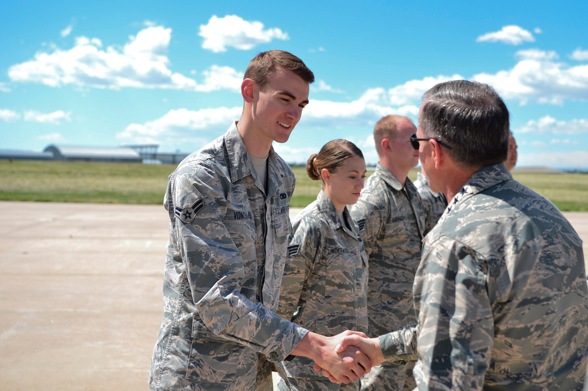 Gen. David L. Goldfein, Chief of Staff of the U.S. Air Force, gives Airman 1st Class Christopher Von Haasl, 140th Maintenance Squadron F-16 Fighting Falcon hydraulics technician, a coin in recognition of his hard work during his visit May 25, 2017, on Buckley Air Force Base, Colo. During his visit, Goldfein walked through several static displays for a mission brief from the 140th Wing, met with space operators from the 460th Operations Group and toured the Aerospace Data Facility-Colorado. (U.S. Air Force photo by Airman 1st Class Holden S. Faul/ Released)