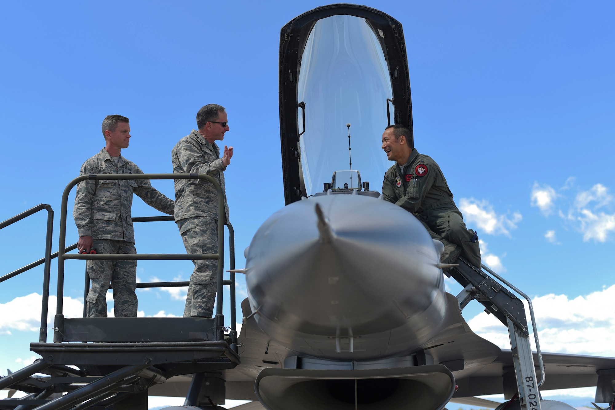 Gen. David L. Goldfein, Chief of Staff of the U.S. Air Force, jokes with Lt. Col. Daniel "Banzai" Bunts, 120th Fighter Squadron F-16 Fighting Falcon pilot, during his visit May 25, 2017, on Buckley Air Force Base, Colo. Bonzai was recognized by Goldfein as the project officer from the first F-22 Raptor overseas deployment. (U.S. Air Force photo by Airman 1st Class Holden S. Faul/ Released)