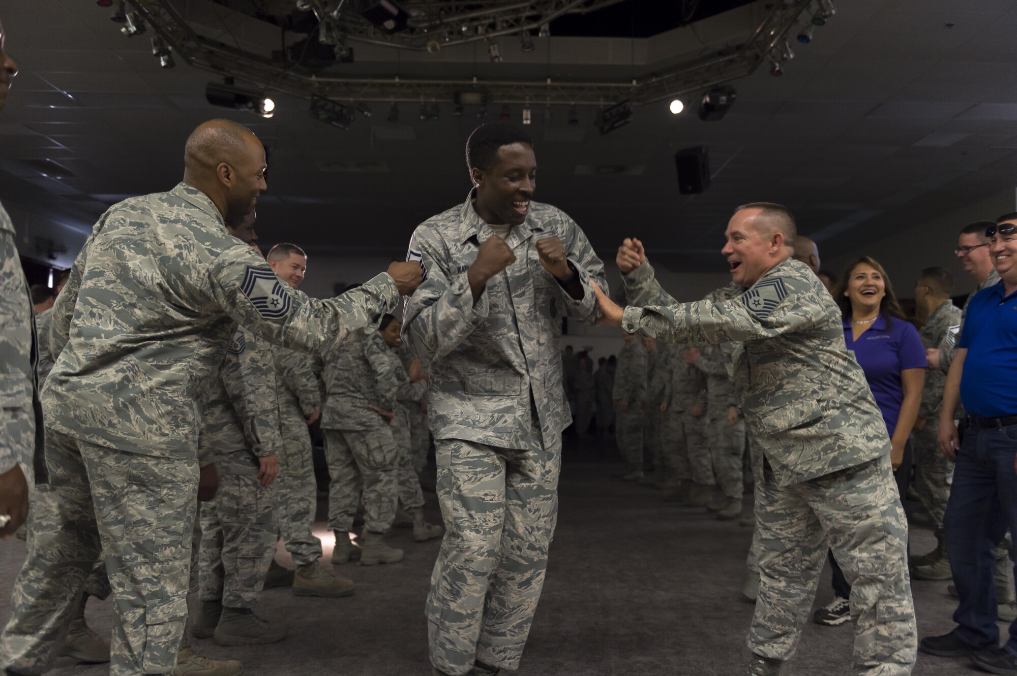 Tech. Sgt. Coliell Washington, 412th Security Forces Squadron, receives a traditional Air Force congratulations for making master sergeant at a release party at Stripes Lounge May 24. (U.S. Air Force photo by Kyle Larson) 			