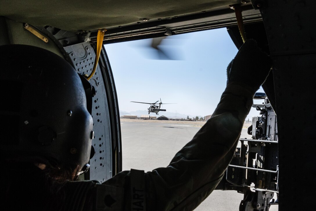 An Army crew chief watches as a UH-60 Black Hawk helicopter prepares to take off on a mission at Kandahar Airfield, Afghanistan, May 27, 2017. Army photo by Capt. Brian Harris