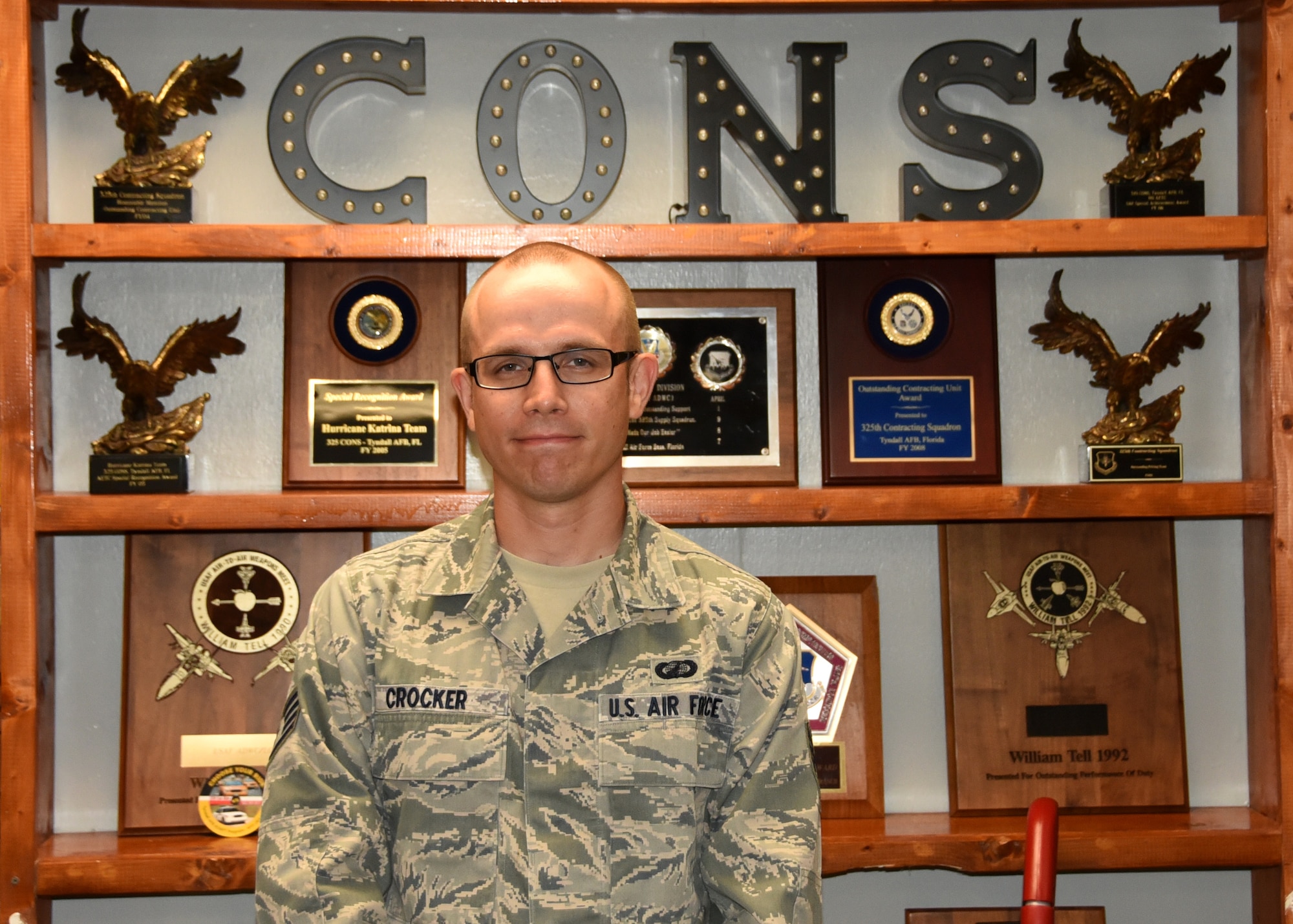 U.S. Air Force Staff Sgt. Nathaniel Crocker, 325th Contracting Squadron contract specialist, poses for a photo in the 325th CONS heritage room at Tyndall Air Force Base, Fla., May 30, 2017. Crocker is one of four 325th CONS Airmen selected to attend Officer Training School at Maxwell Air Force Base, Ala., through the Total Force Officer Training program. 