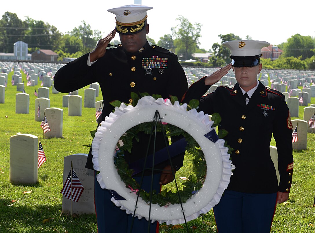 U.S. Marine Corp Lt. Col. Wade Wallace, U.S. Marine Corp Forces Command Headquarters and Service Battalion executive officer, and Staff Sgt. Stephanie Lampear, U.S. Marine Corp Forces Command Headquarters and Service Battalion Installation Personnel Administration Center NCO in charge, render a salute after placing a ceremonial wreath during a Memorial Day Wreath-Laying Ceremony at the Hampton National Cemetery in Hampton, Va., May 29, 2017. During the ceremony, U.S. service members from each branch laid a ceremonial wreath among the gravesites to honor fallen service members, prisoners of war and those missing in action who have served in conflicts around the world. (U.S. Air Force photo/Staff Sgt. Teresa J. Cleveland)