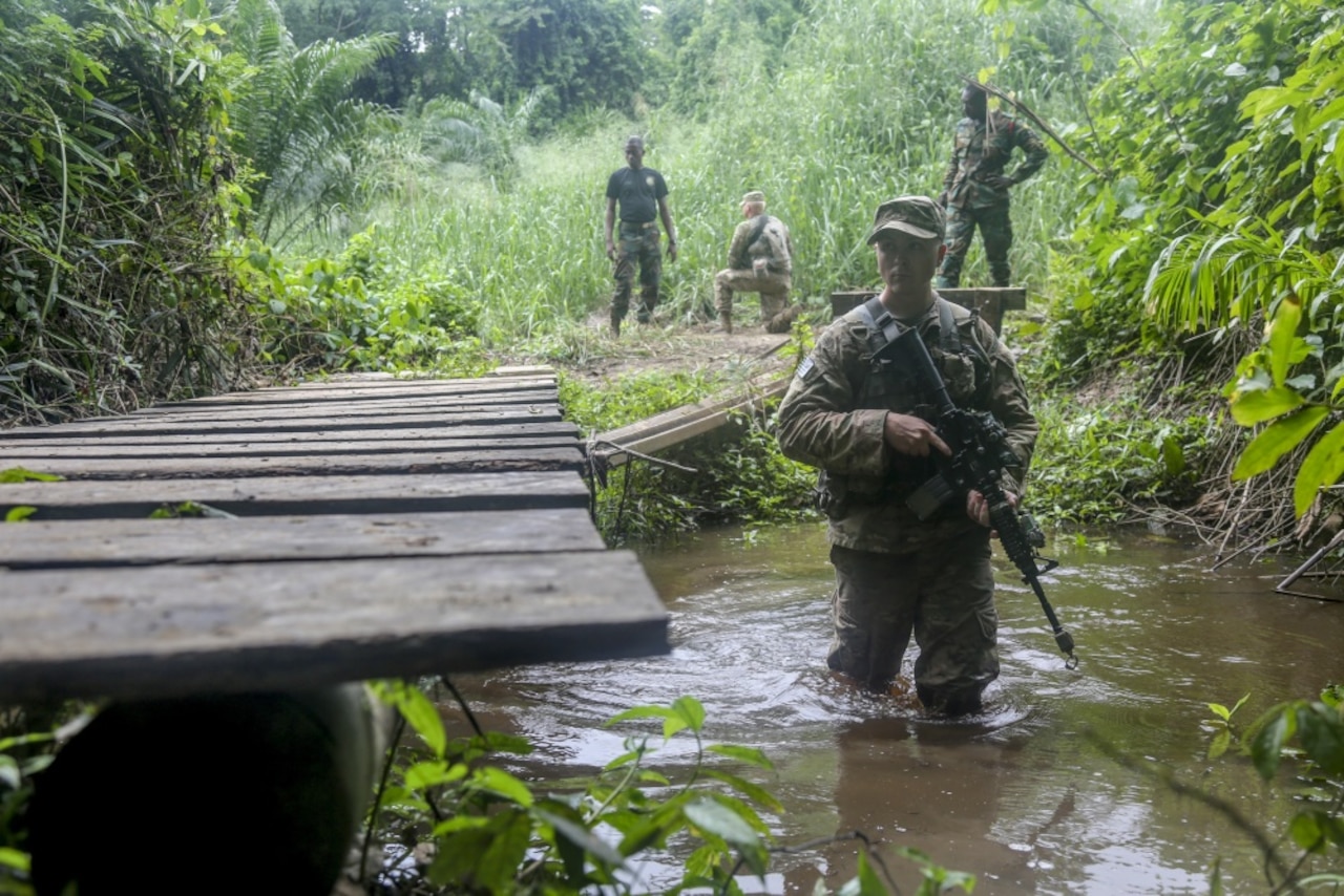 Army Spc. Jake Burley, assigned to the 1st Battalion, 506th Infantry Regiment, maneuvers through a river during United Accord 2017 at the Jungle Warfare School at Achiase military base in Akim Oda, Ghana, May 26, 2017. The school is designed to train participants in counter-insurgency and internal security operations. Army photo by Sgt. Brian Chaney