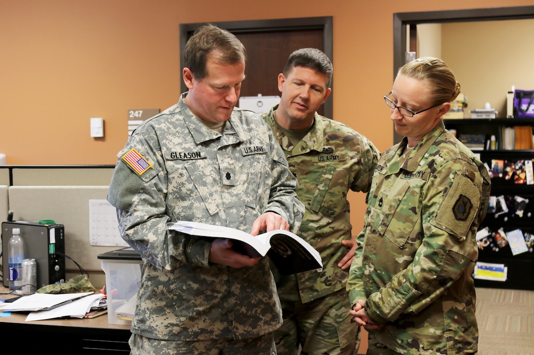 Army Reservist Lt. Col. Robert J. Gleason, judge advocate general, 98th Training Division (Initial Entry Training), speaks with the 98th Inspector General and legal noncommissioned officer during a battle assembly training weekend at Fort Benning, Georgia. Gleason, a Charolette, N.C. resident was recently selected by the U.S. Army Judge Advocate General to serve as a military judge. This elite position is the capstone of his career, according to Gleason. “I’m very honored to have been selected. For me, it’s a dream job. I am very excited about the opportunity.” (U.S. Army Reserve photo by Maj. Michelle Lunato/Released)