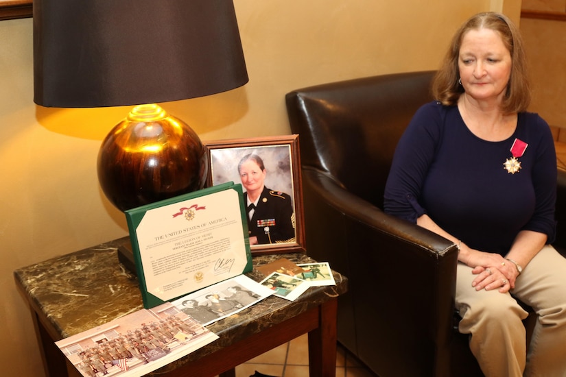Sgt. Maj. (Ret.) Jane Decker, the last division personnel sergeant major for the 98th Training Division (Initial Entry Training), looks back at photos from her time as a Soldier. Decker was originally part of the Women’s Army Corps. A few years later, Decker transferred to the U.S. Army Reserve and served over 40 years as a Citizen-Soldier. The Spencerport, New York resident was awarded a Legion of Merit during a 98th Alumni Luncheon on April 20, 2017 in Rochester, New York. (U.S. Army Reserve photo by Maj. Michelle Lunato/Released)