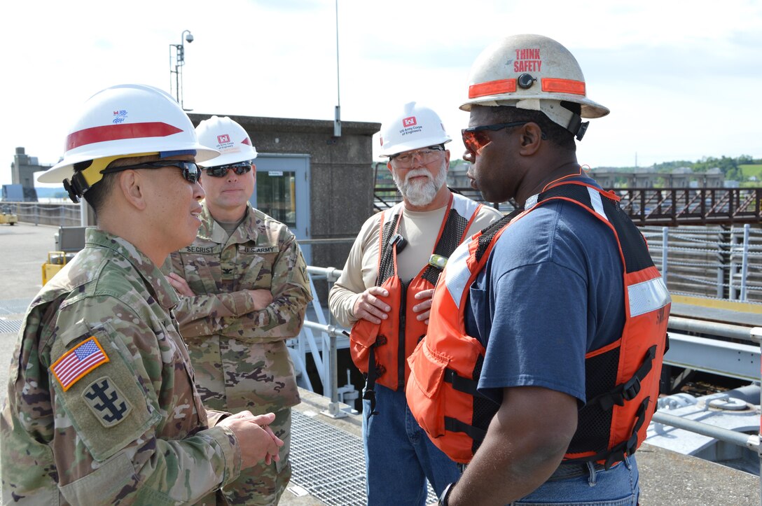 Recently BG Toy, Commanding General, Great Lakes and Ohio River Division, visited the Heavy Fleet of the Regional Rivers Repair Fleet (R3F) at Meldahl Locks and Dam. The Heavy Fleet is currently replacing Miter Gates and BG Toy was able to get a firsthand look at the work and spend some time with the crews of the fleet and the locks and dam.     BG Toy and COL Secrist speak with Fleet Superintendent Darrell Weaver and Welder Sam Lowery during recent visit to R3F.