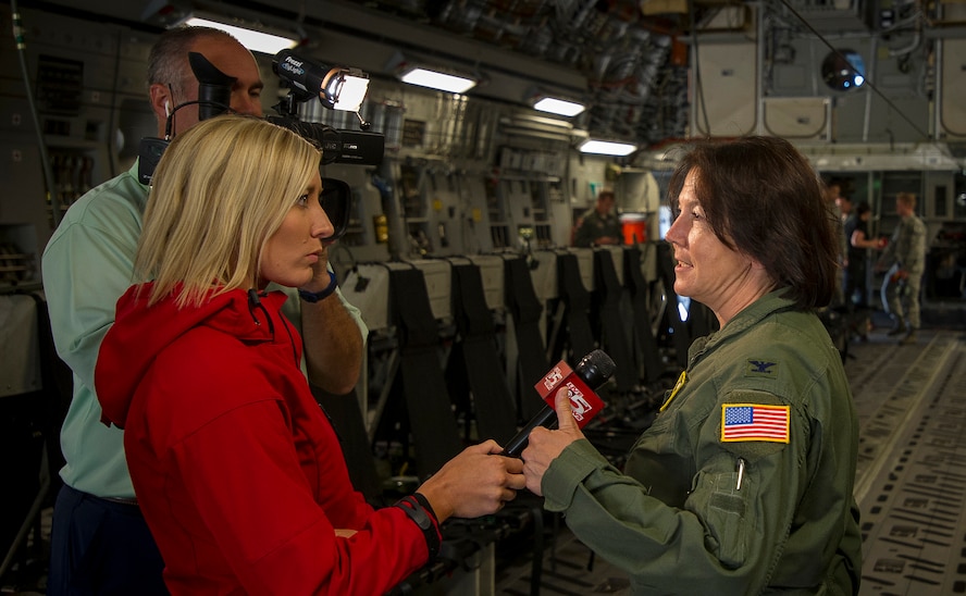 Syndey Ryan, a reporter from WCSC Live 5 News interviews Col. Jeanine McAnaney, 315th Airlift Wing vice commander, prior to a large formation training exercise over Carolina skies May 25. About 1,600 paratroopers from the 82nd Airborne Division packed 18 C-17 Globemaster IIIs from Joint Base Charleston, S.C. en-route to a Fort Bragg, N.C. airdrop. (U.S. Air Force Photo / Tech. Sgt. Bobby Pilch)
