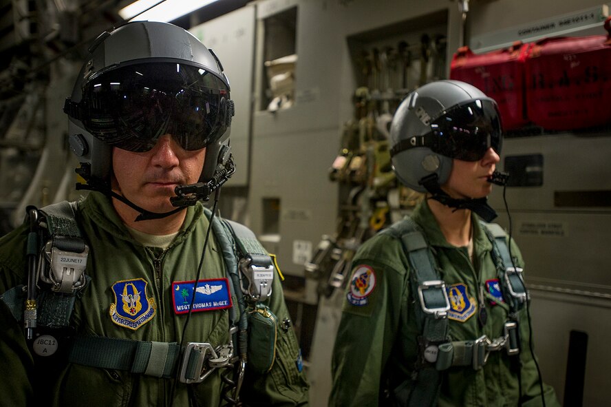 701st Airlift Squadron Loadmaster, Master Sgt. Thomas McGee and Tech. Sgt. Melonie Johnson stand by for take off during an 82nd Airborne Division airdrop from a Charleston C-17 Globemaster III, May 25, at Fort Bragg, North Carolina. Aircrews from the 315th and 437th Airlift Wings  from Joint Base Charleston in 18 C-17 Globemaster IIIs provided the air transportation for the nearly 1,600 paratroopers. (U.S. Air Force Photo / Master Sgt. Shane Ellis)