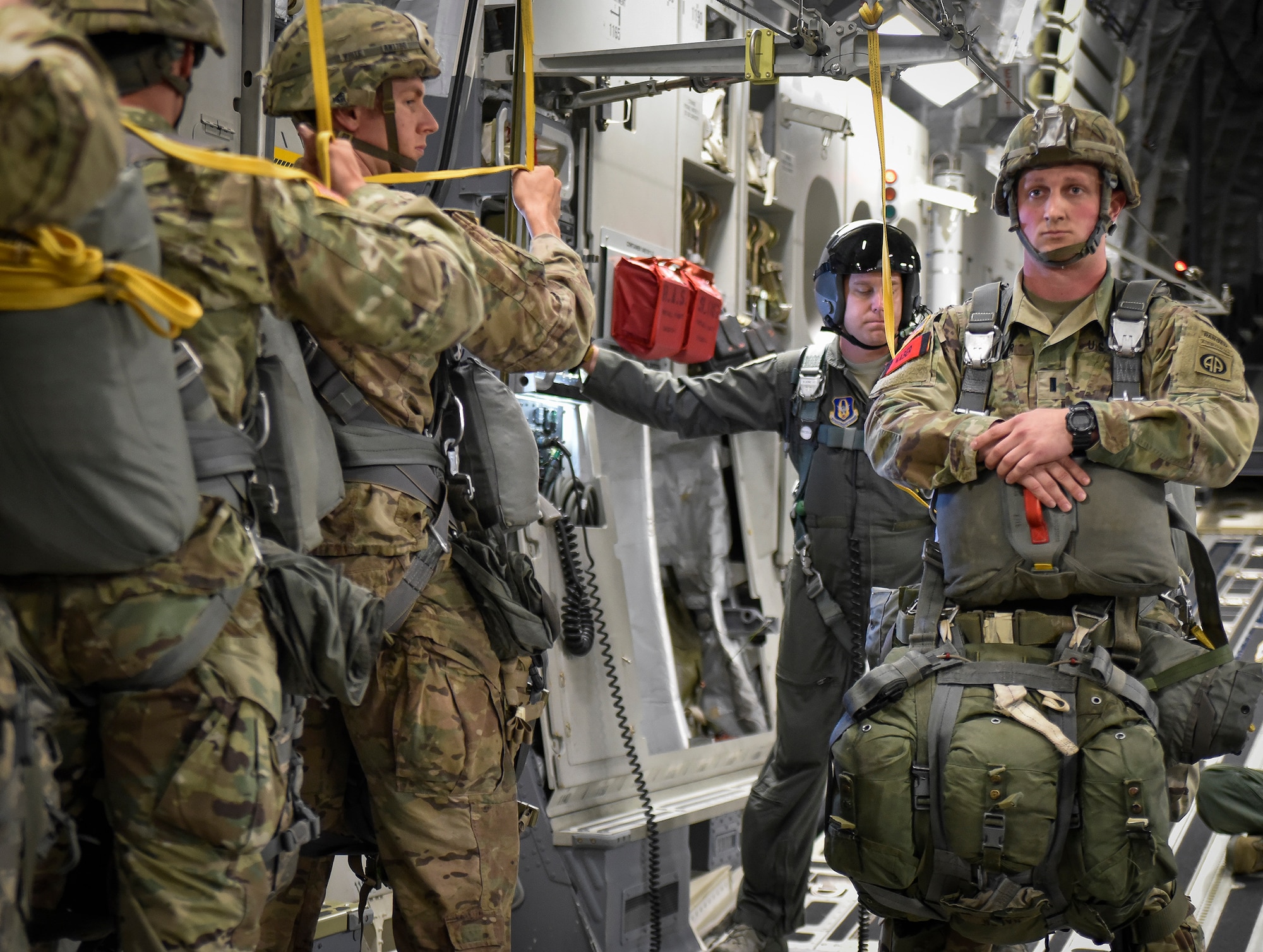 A line of 82nd Airborne Brigade paratroopers line up in front of their jumpmaster in preparation for a jump from a Charleston C-17 Globemaster III, May 25, at Fort Bragg, North Carolina. Aircrews from the 315th and 437th Airlift Wings  from Joint Base Charleston in 18 C-17 Globemaster IIIs provided the air transportation for the nearly 1,600 paratroopers. (U.S. Air Force Photo / Maj. Wayne Capps)