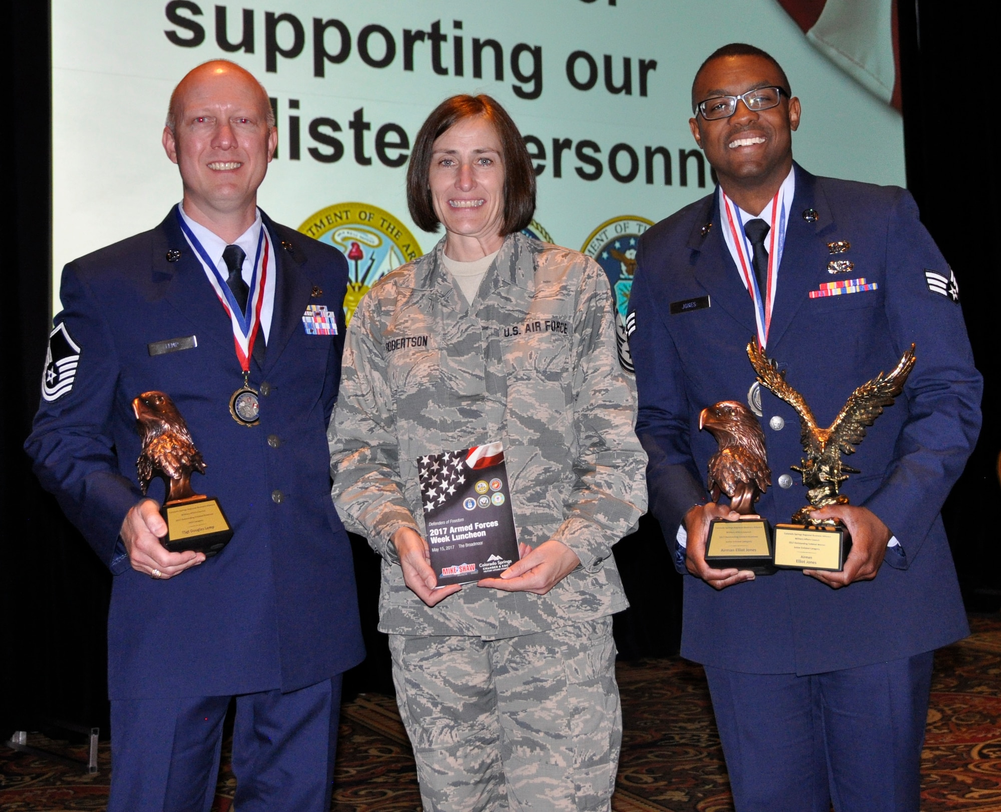 Master Sgt. Douglas Lemp, an air transportation specialist assigned to the Reserve wing’s 39th Aerial Port Squadron, and Senior Airman Elliott Jones, an emergency management specialist assigned to the 302nd Civil Engineer Squadron, pose for a photo with Chief Master Sgt. Vicki Robertson, 302nd Airlift Wing command chief after the Colorado Springs Armed Forces Week Enlisted Awards ceremony held May 15, 2017 in Colorado Springs, Colorado. (U.S. Air Force photo/Ann Skarban)