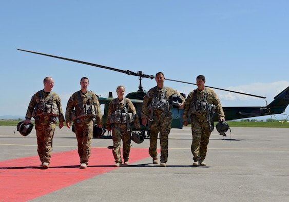 (From left to right) Capt. James Harris, 40th Helicopter Squadron co-pilot, Capt. Matt Thompson, 40th HS pilot, Maj. Melonie Parmley, 341st Medical Group flight surgeon, Tech. Sgts. Andrew Blankenship and Daniel Marchick, 40th HS special mission aviators, walk away from a helicopter May 30, 2017, at Malmstrom Air Force Base, Mont. The crew saved two girls and their dog Tuesday morning after the girls got lost while hiking in Sluice Boxes State Park Monday night. (U.S. Air Force photo/Staff Sgt. Delia Marchick)