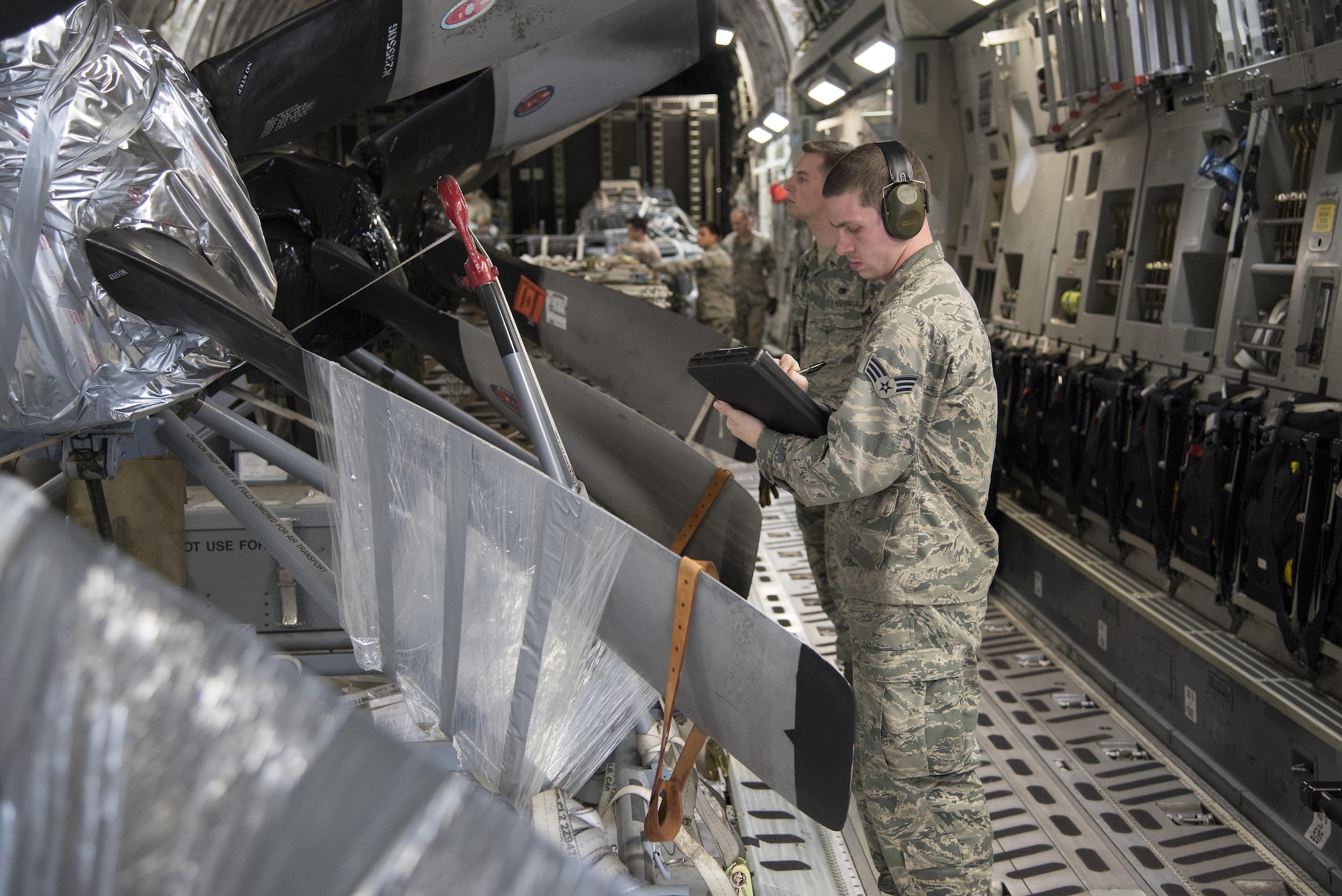 An aerial port expediter assigned to the 436th Aerial Port Squadron confirms the manifest on a C-17 Globemaster III in preparation for an offload at Dover Air Force Base, Del. Careful attention to manifests ensures all cargo is accounted for at every stage of transportation. (U.S. Air Force photo by Senior Airman Aaron J. Jenne)