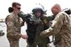 Senior Airman Tom Benedict and Staff Sgt. Rob Rich, Explosive Ordnance Disposal operators, 140th EOD Flight, assist Maj. Gen. Marc Sasseville, Deputy Director of the Air National Guard, as he tries on the bomb suit while visiting with the 140th EOD Flight at Buckley Air Force Base May 7. (U.S. Air National Guard photo by Staff Sgt. Michelle Alvarez-Rea)