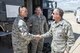Gen. David Goldfein, Chief of Staff of the U.S. Air Force, coins Senior Master Sgt. Dick Gibbons, flight chief, 140th EOD Flight, during his visit to Buckley Air Force Base May 25. (U.S. Air National Guard Photo by Senior Master Sgt. John Rohrer)