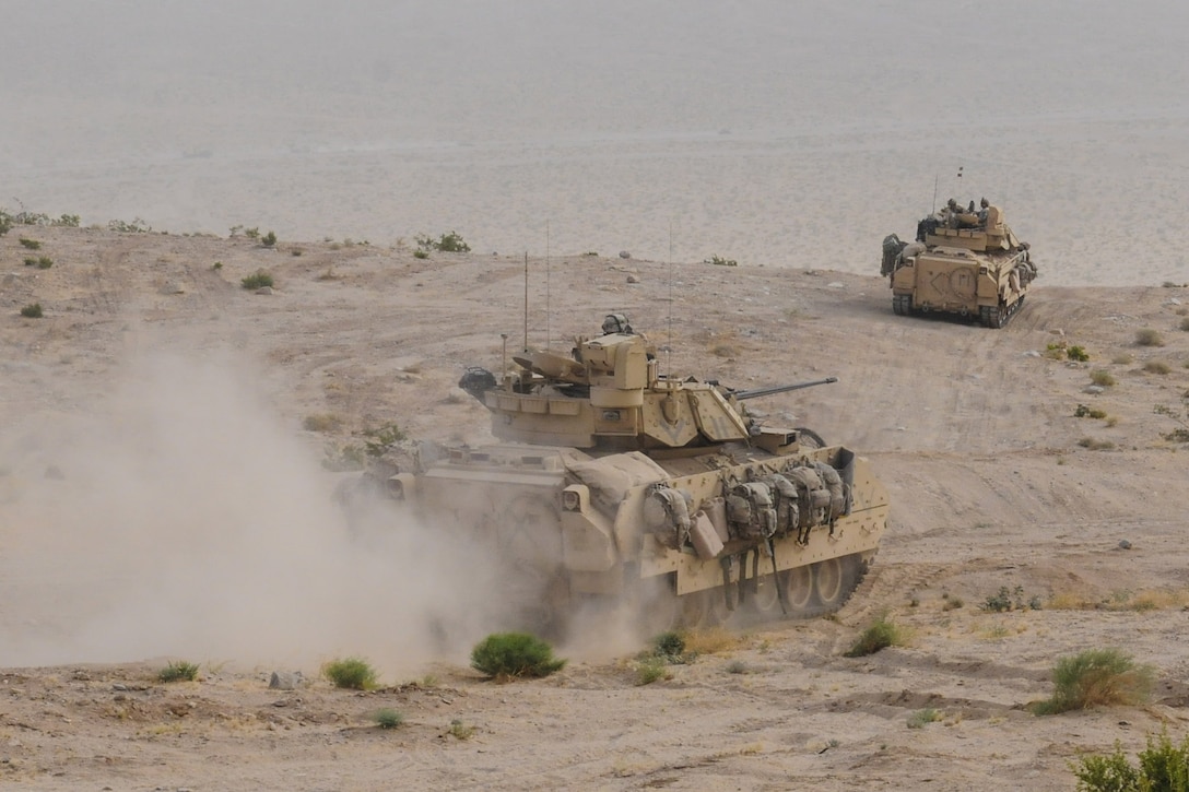 Bradleys kick up dirt as they roll through the desert while engaging the enemy in a force-on-force exercise during the 155th Armored Brigade Combat Team’s rotation at the National Training Center, Fort Irwin, Calif., May 30, 2017. Mississippi National Guard photo by Army Staff Sgt. Veronica McNabb