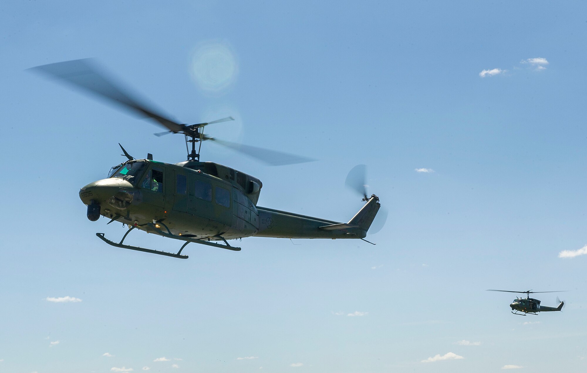 UH-1N Iroquois hueys from the 54th Helicopter Squadron hover over the missile complex, N.D., May 23, 2017. Airmen from the 54th HS teamed with defenders from the 791st Missile Security Forces Squadron to conduct security response training sorties. (U.S. Air Force photo/Senior Airman Apryl Hall)
