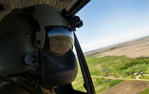 Tech. Sgt. Jamie Aulbach, 54th Helicopter Squadron flight engineer, looks out over the countryside during a training sortie in the missile complex, N.D., May 23, 2017. Aulbach monitors all aircraft systems, ensures proper weight balance of the aircraft, conducts pre and post-flight inspections, and be prepares for potential in-flight emergencies. (U.S. Air Force photo/Senior Airman Apryl Hall)