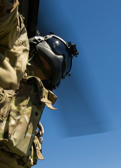 Tech. Sgt. Jamie Aulbach, 54th Helicopter Squadron flight engineer, prepares for landing during a training sortie in the missile complex, N.D., May 23, 2017. Airmen from the 54th HS teamed with 791st Missile Security Forces Squadron defenders to conduct security response training sorties. (U.S. Air Force photo/Senior Airman Apryl Hall)