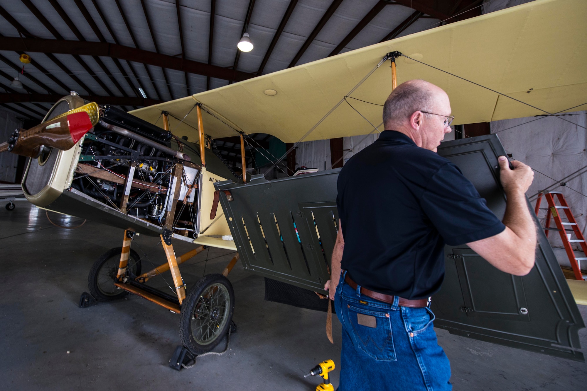 Members of Friends of Jenny perform rountine maintenace on the J-4 Jenny, May, 4, 2017 at Bowling Green, Kentucky. Other than the fact it was the first training plane, in 1917 Congress made the largest single appropriation in the United States, 640 million dollars to build an Air Force because at that point there were around 32 airplanes, in which, 10 or 12 were serviceable. (U.S. Air Force photo/Senior Airman Tristin English)