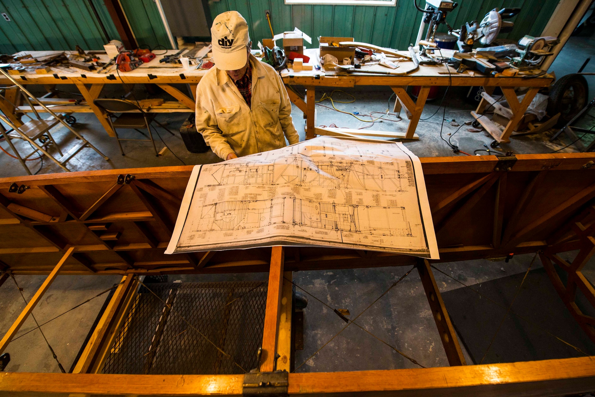 Dorian Walker, Chairman of Friends of Jenny, looks over and studies blueprints, May, 4, 2017 at Bowling Green, Kentucky. FOJ's mission was to build a Jenny-but to build it to fly. They wanted to do it in a short amount of time and not spend anywhere from 7 to 20 years building it and it not fly, so 5,720 hours later, over the course of 14 months, three teams of individuals built the Jenny. (U.S. Air Force photo/Senior Airman Tristin English)