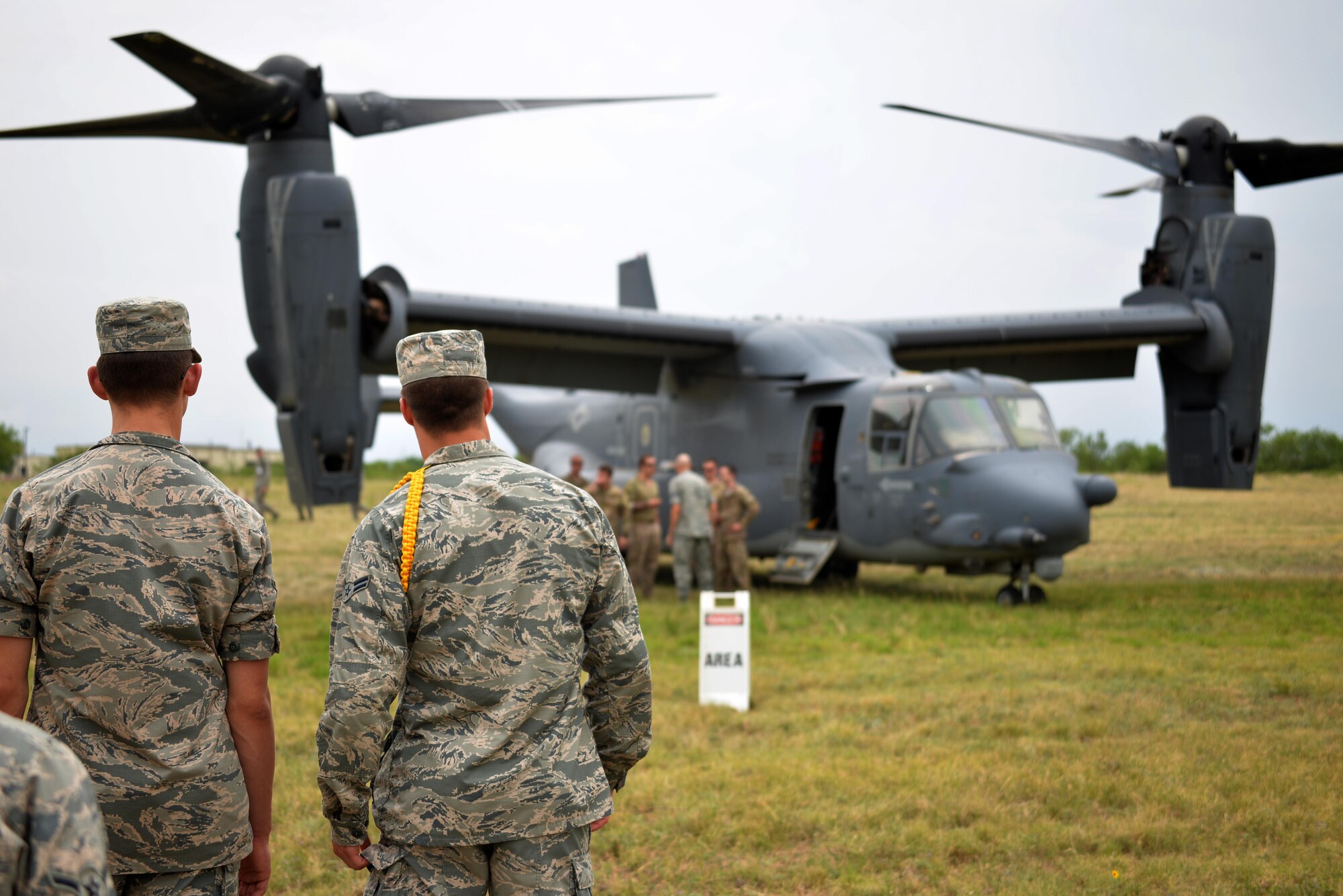 Airmen await their turn to see the interior of the CV-22 Osprey on Goodfellow Air Force Base, Texas, May 30, 2017. The aircraft landed on Goodfellow after travelling from Cannon Air Force Base, New Mexico to provide Goodfellow students with an orientation on special operations missions and aircraft they may support after graduation. (U.S. Air Force Photo by James R. Orlando/Released)