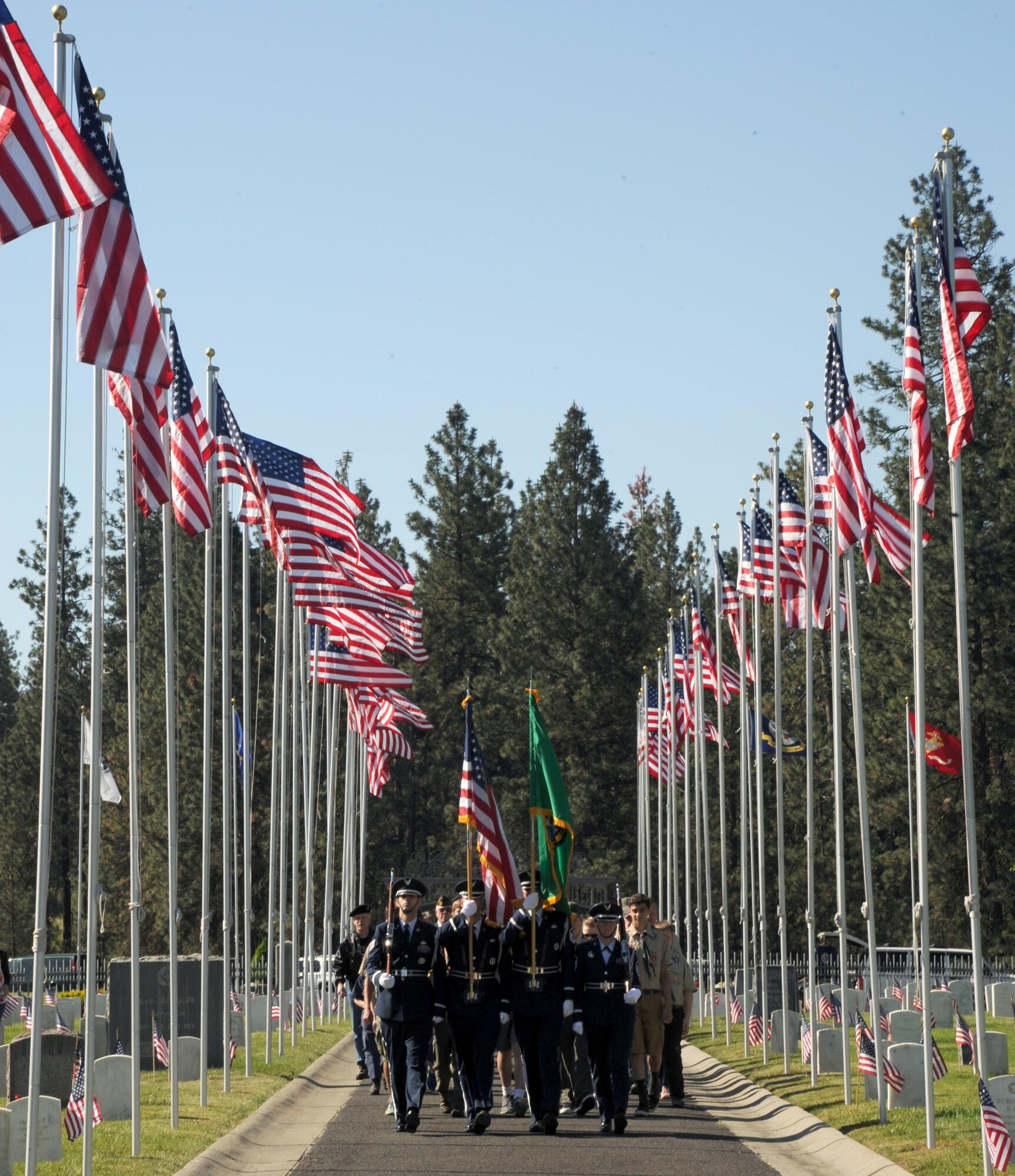Members of the Fairchild Air Force Base Honor Guard lead groups of Boy Scouts, veterans and civilians through Fort George Wright Cemetery on Memorial Day May 29, 2017. The local Veterans of Foreign Wars chapter lead a ceremony honoring service members who have lost their lives. Col. Matthew Fritz, 92nd Air Refueling Wing vice commander, also spoke at the ceremony. (U.S. Air Force photo by Master Sgt. J.G. Buzanowski)