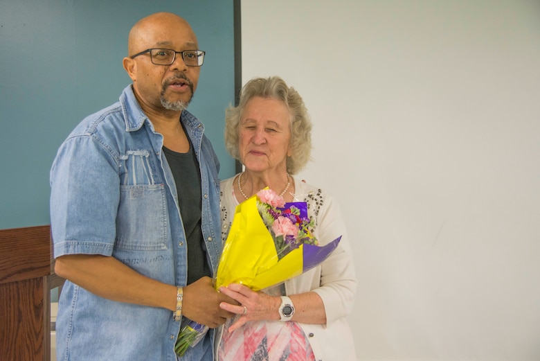 Greg Skinner, Cyberspace Support Squadron mission readiness training flight chief, presents Karen Bunch, CYSS mission readiness training manager a bouquet of flowers and speaks about his appreciation for her during a Wingman Day luncheon at Scott Air Force Base, Illinois, May 12, 2017. Over the last 50 years Bunch has worked for the Air Force including Headquarters Mobility Air Command, Air Force Communications Service, Air Force Network Integration Center and Air FOrce Communications Agency. (U.S. Air Force photo by Airman 1st Class Daniel Garcia)