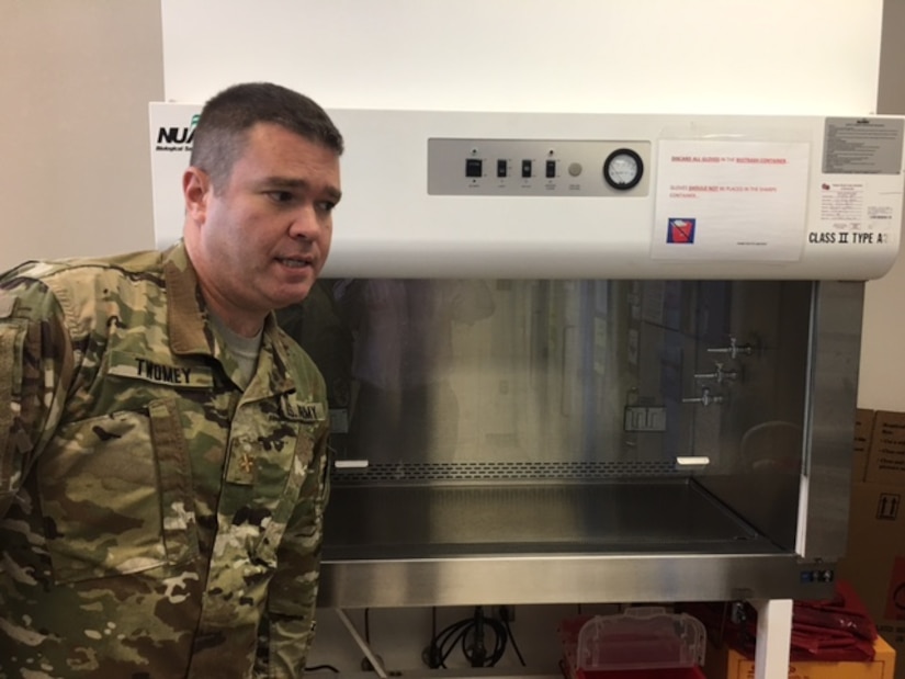 Army Maj. Patrick Twomey, chief of the Walter Reed Army Institute of Research Clinical Trials Center, stands next to a fume hood at WRAIR in Silver Spring, Md., May 31, 2017. Most vaccine samples arrive at WRAIR readymade, but others first require some preparatory mixing under a fume hood. DoD photo by Rick Docksai
