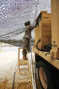 Pfc. Makayla Black with the 810th Quartermaster Company of Cincinnati, Ohio, checks the generator for a Reverse-Osmosis Water Purification Unit at Big Sandy Lake on May 10, 2017, during operations for the 86th Training Division’s Warrior Exercise 86-17-02 at Fort McCoy, Wis. The Warrior Exercise provides unique training opportunities for various Soldiers in various military occupation specialties to train together on simulated combat missions and to work together as a team, just like they would in a real-world environment. The 810th provided the majority of the drinkable water used in the exercise through water-purification efforts. (U.S. Army Photo by Scott T. Sturkol, Public Affairs Office, Fort McCoy, Wis.)