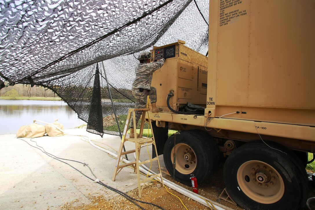 Pfc. Makayla Black with the 810th Quartermaster Company of Cincinnati, Ohio, checks the generator for a Reverse-Osmosis Water Purification Unit at Big Sandy Lake on May 10, 2017, during operations for the 86th Training Division’s Warrior Exercise 86-17-02 at Fort McCoy, Wis. The Warrior Exercise provides unique training opportunities for various Soldiers in various military occupation specialties to train together on simulated combat missions and to work together as a team, just like they would in a real-world environment. The 810th provided the majority of the drinkable water used in the exercise through water-purification efforts. (U.S. Army Photo by Scott T. Sturkol, Public Affairs Office, Fort McCoy, Wis.)