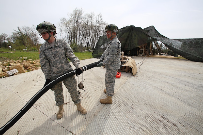 Pfc. Makayla Black and Spc. Zhixin Wang with the 810th Quartermaster Company of Cincinnati, Ohio, place a hose for a Reverse-Osmosis Water Purification Unit into Big Sandy Lake on May 10, 2017, during operations for the 86th Training Division’s Warrior Exercise 86-17-02 at Fort McCoy, Wis. The Warrior Exercise provides unique training opportunities for various Soldiers in various military occupation specialties to train together on simulated combat missions and to work together as a team, just like they would in a real-world environment. The 810th provided the majority of the drinkable water used in the exercise through water-purification efforts. (U.S. Army Photo by Scott T. Sturkol, Public Affairs Office, Fort McCoy, Wis.)