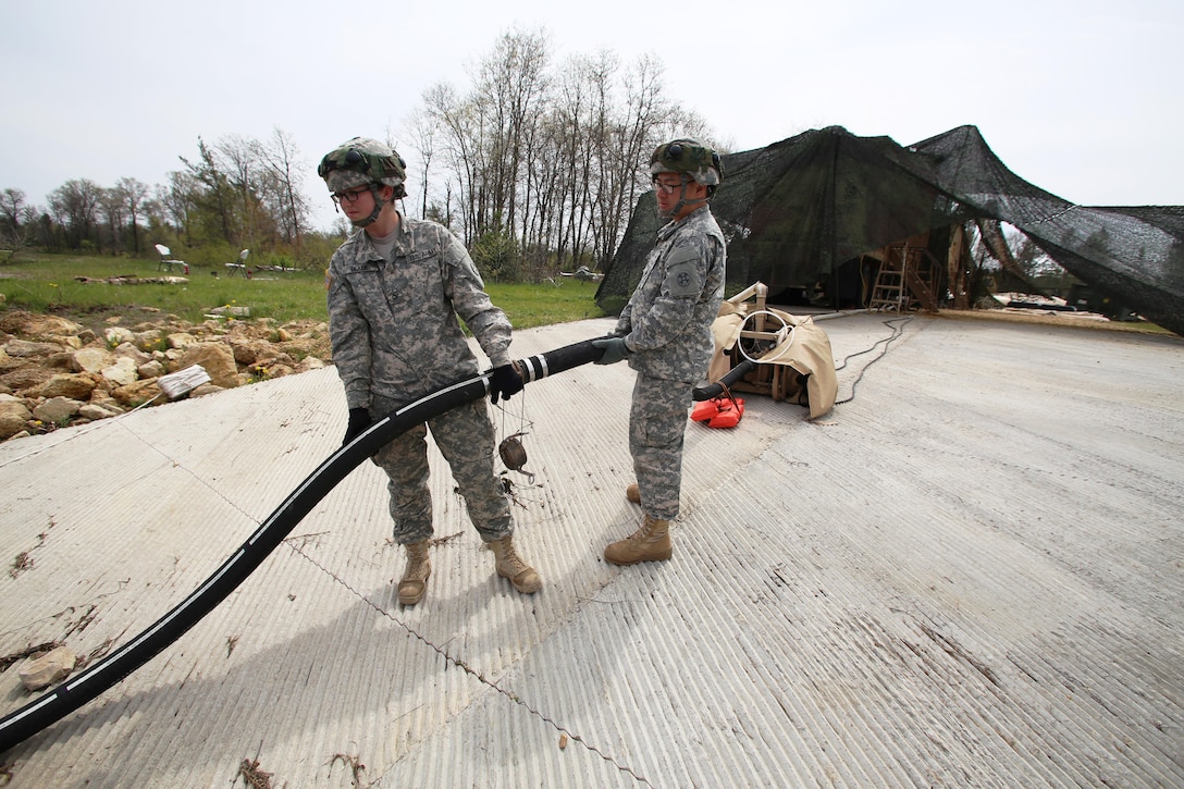 Pfc. Makayla Black and Spc. Zhixin Wang with the 810th Quartermaster Company of Cincinnati, Ohio, place a hose for a Reverse-Osmosis Water Purification Unit into Big Sandy Lake on May 10, 2017, during operations for the 86th Training Division’s Warrior Exercise 86-17-02 at Fort McCoy, Wis. The Warrior Exercise provides unique training opportunities for various Soldiers in various military occupation specialties to train together on simulated combat missions and to work together as a team, just like they would in a real-world environment. The 810th provided the majority of the drinkable water used in the exercise through water-purification efforts. (U.S. Army Photo by Scott T. Sturkol, Public Affairs Office, Fort McCoy, Wis.)