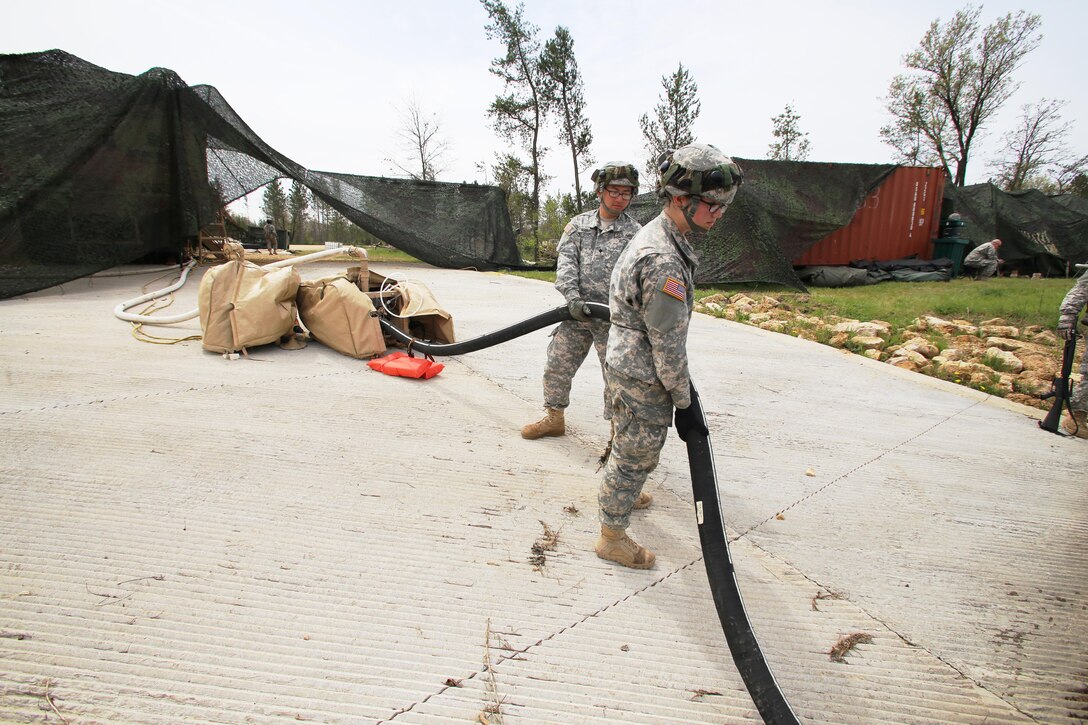 Pfc. Makayla Black and Spc. Zhixin Wang with the 810th Quartermaster Company of Cincinnati, Ohio, place a hose for a Reverse-Osmosis Water Purification Unit into Big Sandy Lake on May 10, 2017, during operations for the 86th Training Division’s Warrior Exercise 86-17-02 at Fort McCoy, Wis. The Warrior Exercise provides unique training opportunities for various Soldiers in various military occupation specialties to train together on simulated combat missions and to work together as a team, just like they would in a real-world environment. The 810th provided the majority of the drinkable water used in the exercise through water-purification efforts. (U.S. Army Photo by Scott T. Sturkol, Public Affairs Office, Fort McCoy, Wis.)