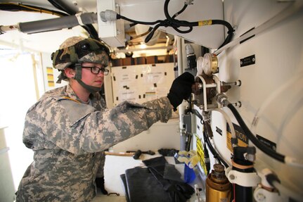 Pfc. Makayla Black with the 810th Quartermaster Company of Cincinnati, Ohio, works on a Reverse-Osmosis Water Purification Unit at Big Sandy Lake on May 10, 2017, during operations for the 86th Training Division’s Warrior Exercise 86-17-02 at Fort McCoy, Wis. The Warrior Exercise provides unique training opportunities for various Soldiers in various military occupation specialties to train together on simulated combat missions and to work together as a team, just like they would in a real-world environment. The 810th provided the majority of the drinkable water used in the exercise through water-purification efforts. (U.S. Army Photo by Scott T. Sturkol, Public Affairs Office, Fort McCoy, Wis.)