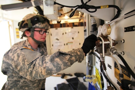 Pfc. Makayla Black with the 810th Quartermaster Company of Cincinnati, Ohio, works on a Reverse-Osmosis Water Purification Unit at Big Sandy Lake on May 10, 2017, during operations for the 86th Training Division’s Warrior Exercise 86-17-02 at Fort McCoy, Wis. The Warrior Exercise provides unique training opportunities for various Soldiers in various military occupation specialties to train together on simulated combat missions and to work together as a team, just like they would in a real-world environment. The 810th provided the majority of the drinkable water used in the exercise through water-purification efforts. (U.S. Army Photo by Scott T. Sturkol, Public Affairs Office, Fort McCoy, Wis.)