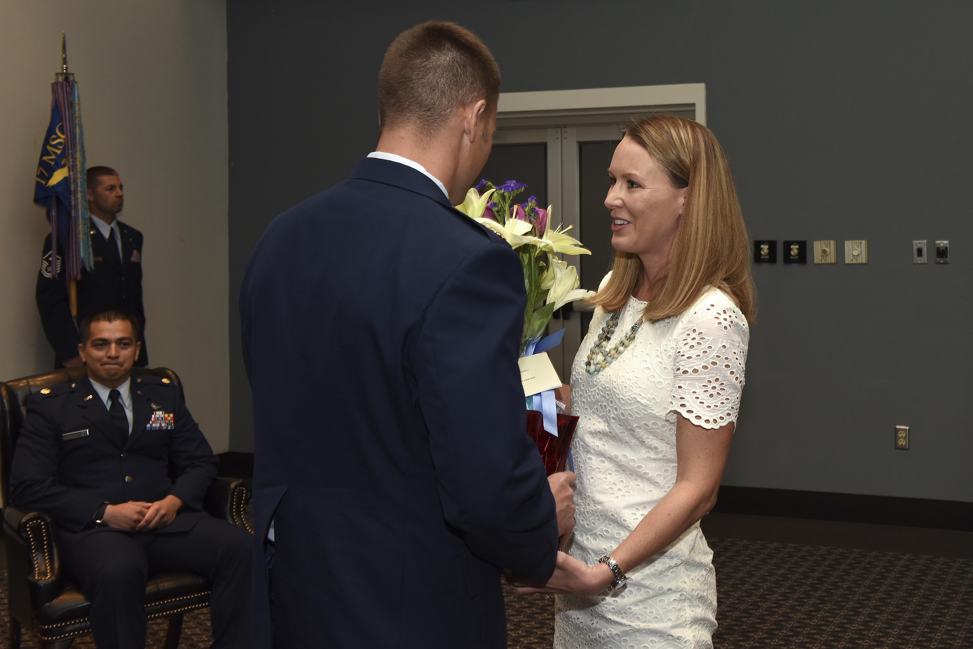 U.S. Air Force Maj. Stephen Maddox, 17th Communications Squadron commander, hands flowers to his wife during the 17th CS change of command ceremony at the Event Center on Goodfellow Air Force Base, Texas, May 31, 2017. During change of command ceremonies it’s custom to give flowers to a departing commander’s wife as a symbol of appreciation for their support.
