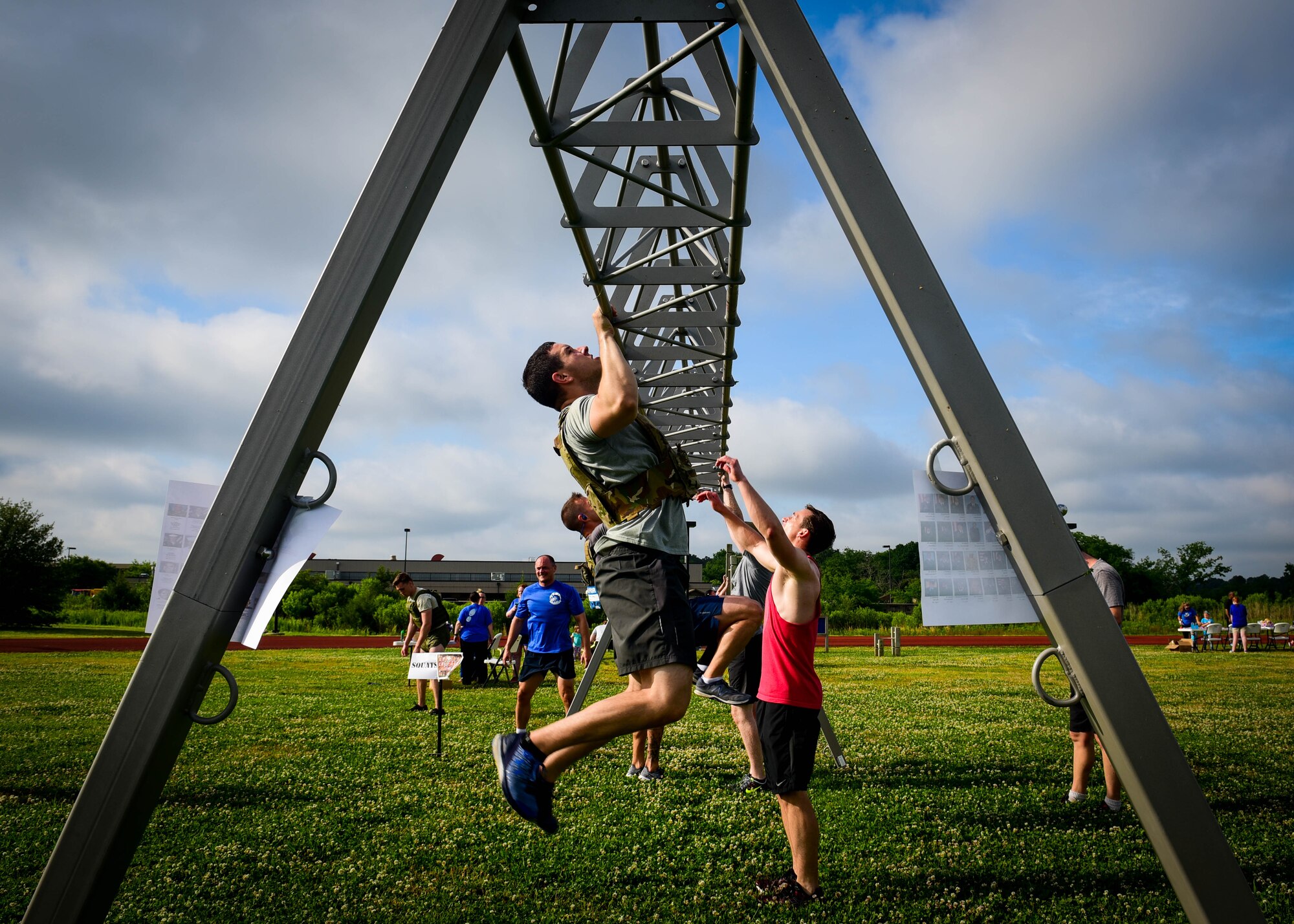 U.S. service members and their families complete the pull-up portion of a Memorial Day Murph and Pararescue Workout event at Joint Base Langley-Eustis, Va., May 29, 2017. During the Murph Workout, members ran a total of two miles, performed a total of 100 pullups, 200 pushups and 300 squats. (U.S. Air Force photo/Staff Sgt. Areca T. Bell) 