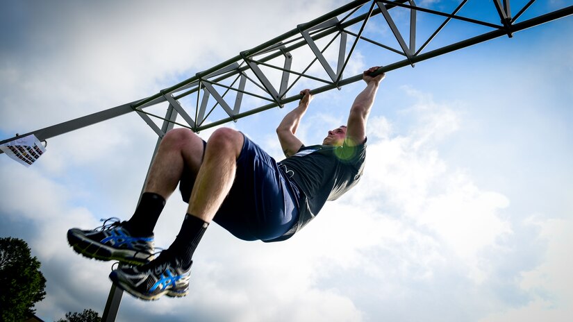 U.S. Air Force Senior Airman Derek Seifert, 633rd Air Base Wing photojournalist, performs a pull-up during a Memorial Day Murph and Pararescue Workout event at Joint Base Langley-Eustis, Va., May 29, 2017. Throughout the Murph Workout, participants ran a total of two miles, performed a total of 100 pullups, 200 pushups and 300 squats. (U.S. Air Force photo/Staff Sgt. Areca T. Bell)