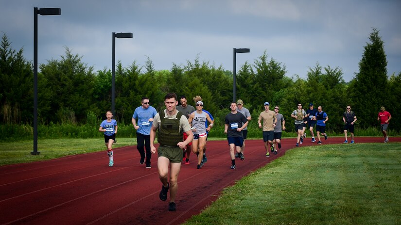 U.S. service members and their families participate in a 1-mile run during the Memorial Day Murph and Pararecue Workout event at Joint Base Langley-Eustis, Va., May 29, 2017. During the workout, members ran a total of two miles, performed a total of 100 pullups, 200 pushups and 300 squats. (U.S. Air Force photo/Staff Sgt. Areca T. Bell)
