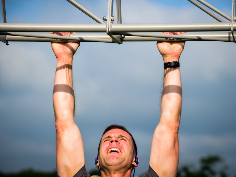 A participant does a pullup during a Memorial Day Murph and Pararescue Workout event at Joint Base Langley-Eustis, Va., May 29, 2017. Participants who opted to complete the Pararescue Workout ran a total of two miles, performed a total of 100 pullups, 400 burpees, 300 squats, 100 sit-ups and 400-meter tire flip. (U.S. Air Force photo/Staff Sgt. Areca T. Bell)