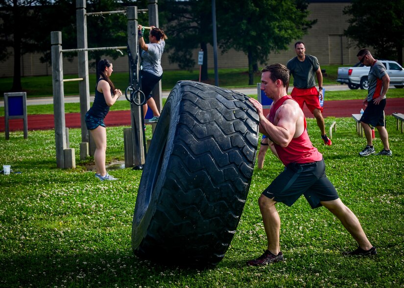 U.S. Air Force Senior Airman Austin Goins, 633rd Medical Operations Squadron aerospace medical services technician, flips a tire during a Memorial Day Murph and Pararescue Workout event at Joint Base Langley-Eustis, Va., May 29, 2017. Participants who opted to complete the Pararescue Workout ran a total of two miles, performed a total of 100 pullups, 400 burpees, 300 squats, 100 sit-ups and 400-meter tire flip. (U.S. Air Force photo/Staff Sgt. Areca T. Bell)