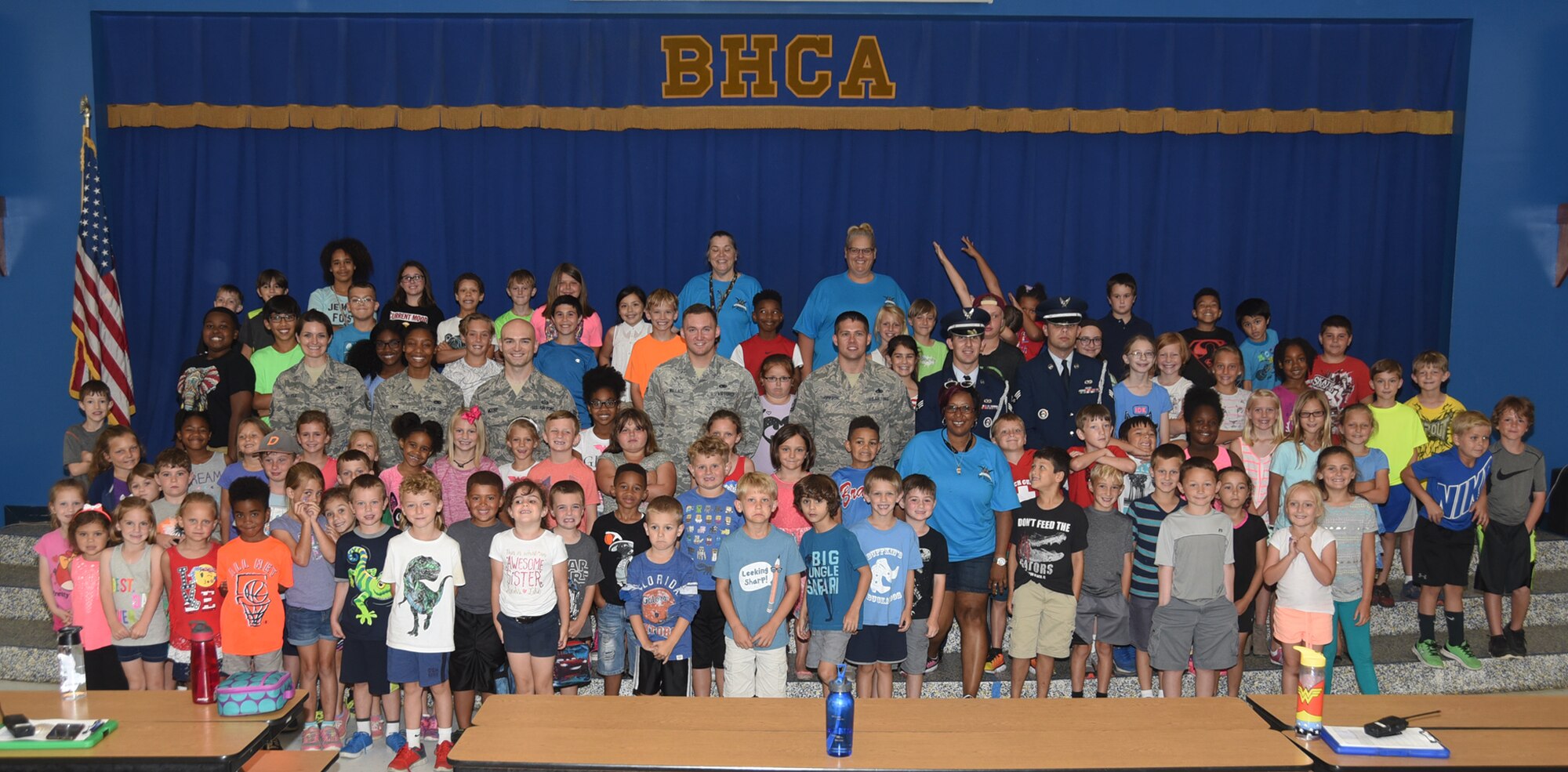 Bay Haven Charter Academy summer program children and staff members take a group photo with Team Tyndall Airmen May 30, 2017. The Airmen were invited to talk about the meaning of the U.S. flag, answer questions and spent time talking to the children. (U.S. Air Force photo by Senior Airman Sergio A. Gamboa/Released)