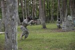 U.S. Army Staff Sgt. Wylie Nicholas, a Delta Detachment, 1st Space Company, Joint Tactic Army Ground Station engagement control team leader, provides cover for his teammates while they flank simulated enemy troops at Misawa Air Base, Japan, May 24, 2017. After many practices, Soldiers tested their strategy to secure the objective during a paintball round against opposing forces. 