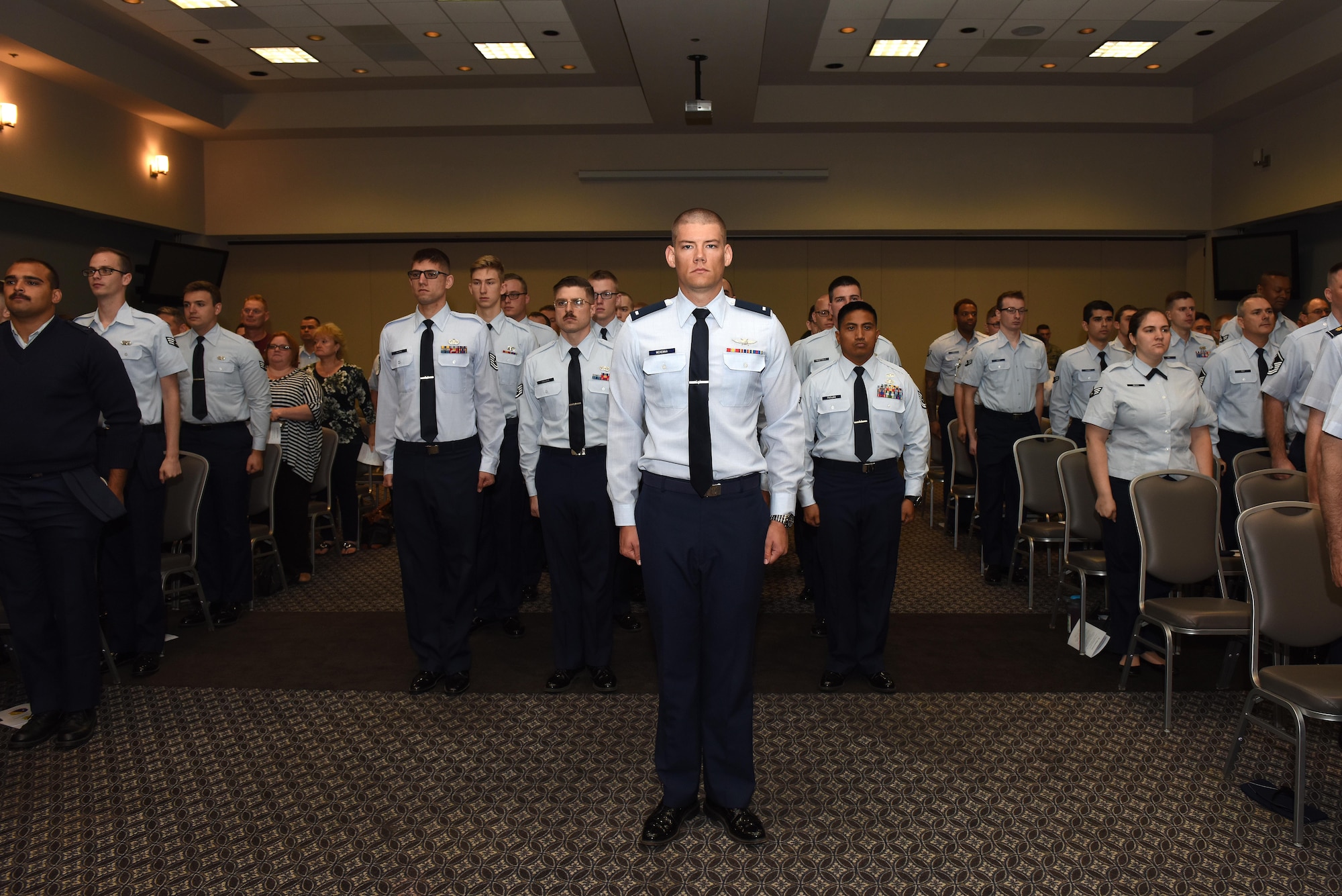 17th Communications Squadron stands at attention in respect of their departing and incoming commanders during the 17th CS Change of Command ceremony at the Event Center on Goodfellow Air Force Base, Texas, May 31, 2017. During the ceremony the unit would salute the departing and incoming commander. (U.S. Air Force photo by Airman 1st Class Caelynn Ferguson/ Released)