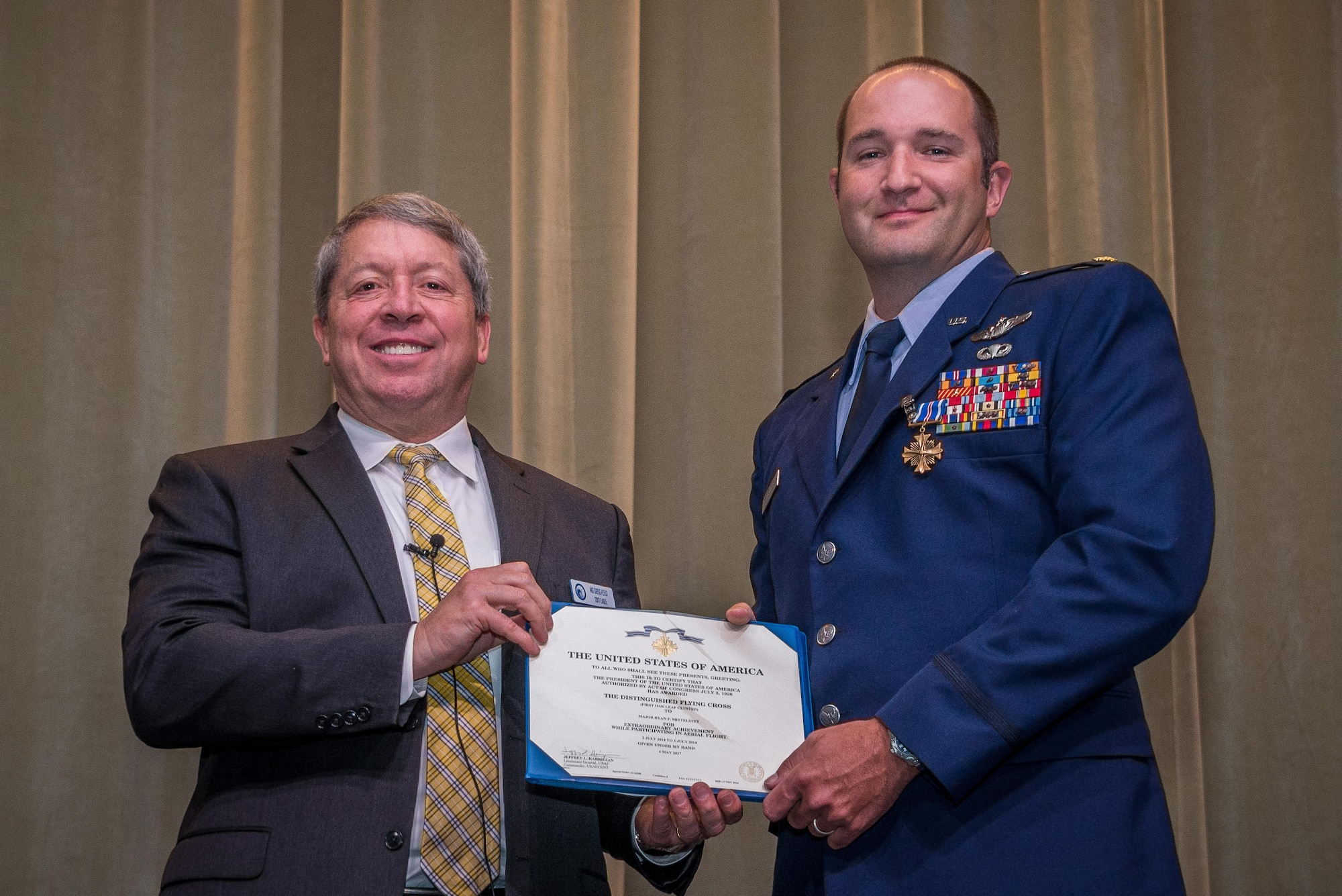 Retired Air Force Maj. Gen. Gregory A. Feest awards Air Command and Staff College student Maj. Ryan Mittelstet the Distinguished Flying Cross with Valor for his heroism in combat, May 30, 2017. Feest is one of the Eagles for the Gathering of the Eagles 2017. The GOE program brings together aviation heroes and pioneers to share their experiences and provide inspiration to future aviation leaders. Feest was a command pilot with more than 5,600 flying hours, including more than 800 combat hours earned during operations: Just Cause; Desert Storm; Iraqi Freedom; and Enduring Freedom. (U.S. Air Force Photo/ Donna L. Burnett/Released)
