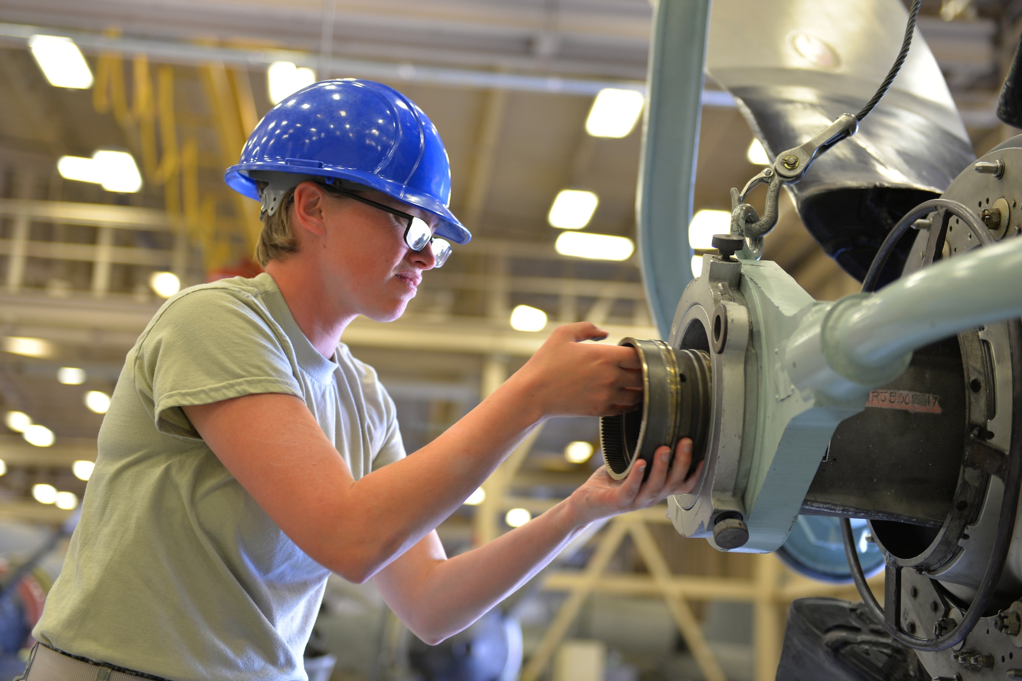Airman Kellie Bullard, 361st Training Squadron student assists with installation of a 54H60 Hamilton Sundstrand propeller by operating a five ton capacity overhead hoist at Sheppard Air Force Base, Texas, May 24, 2017. This model propeller and engine combination are installed on the C-130H aircraft. (U.S. Air Force photo by Liz H. Colunga/Released)