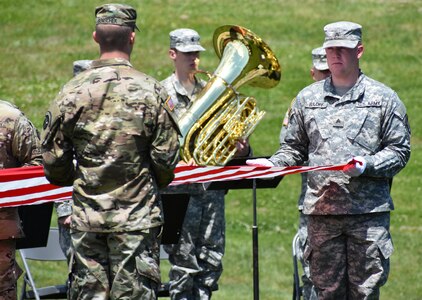 Members of the Iowa National Guard fold the flag as the band plays while conducting Retreat as the 88th Regional Support Command dedicates a plaque at Camp Dodge, Iowa on May 25, in honor of the 88th Infantry Division's beginning there in 1917. During the Command Retreat, Airmen, Soldiers, and Civilians are recognized by Maj. Gen. Timothy Orr, Adjutant General of the Iowa National Guard, for their contributions to the Guard and their communities, state and nation.